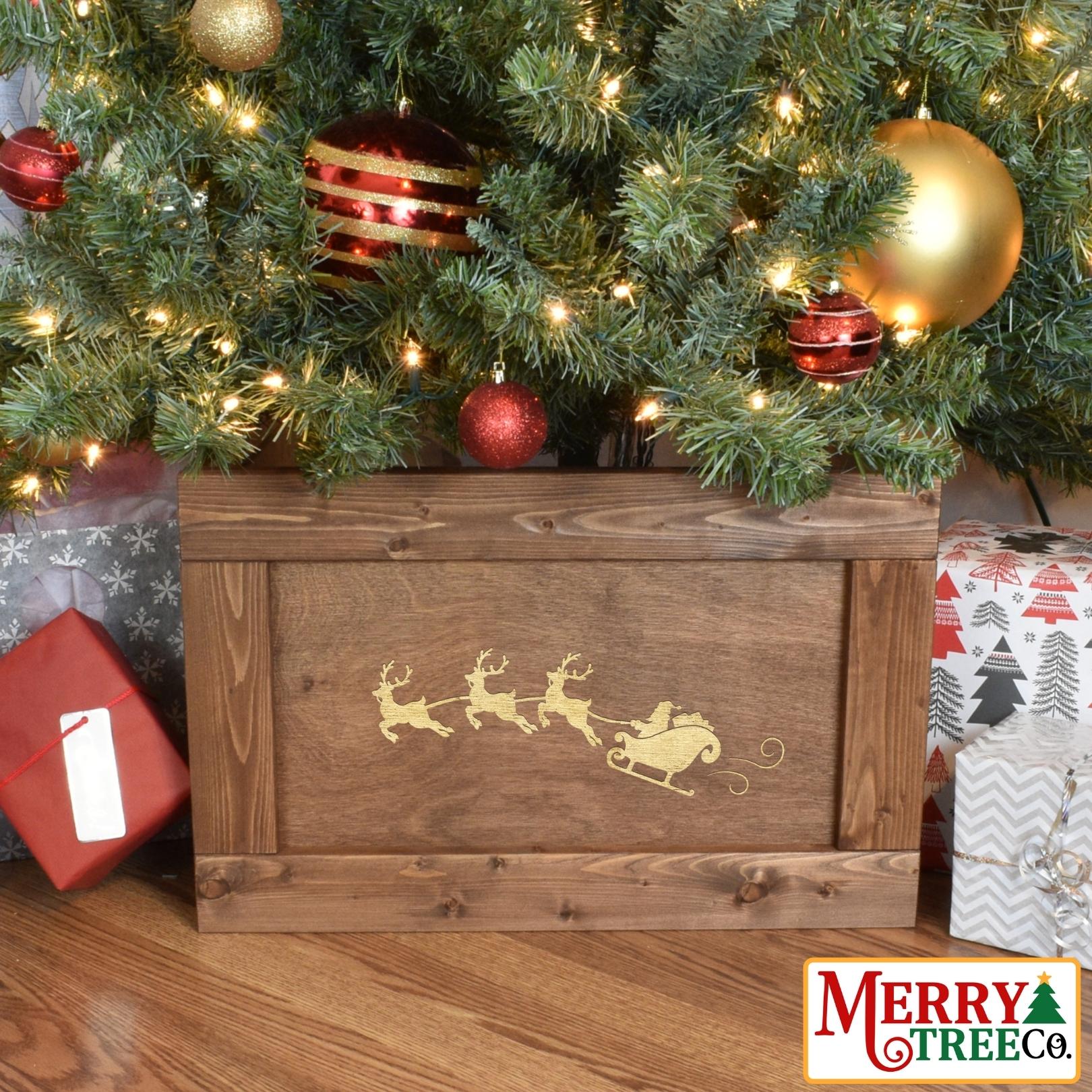 Light brown stained wooden christmas box with santa in his sleigh pulled by three reindeer.