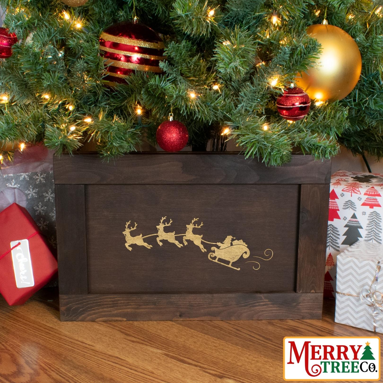 Dark brown wooden Christmas Tree box with santa in his sleigh pulled by three reindeer.