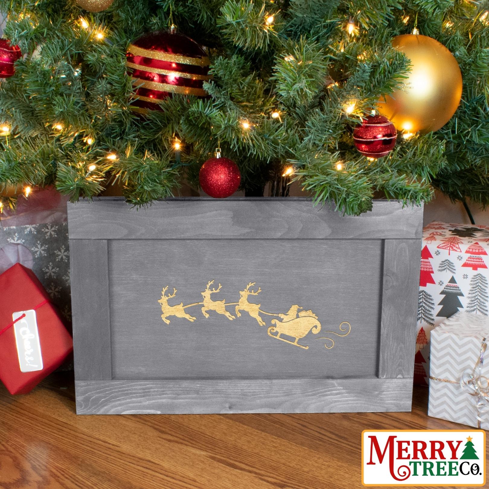 Grey tree box with Santa in his sleigh pulled by three reindeer.